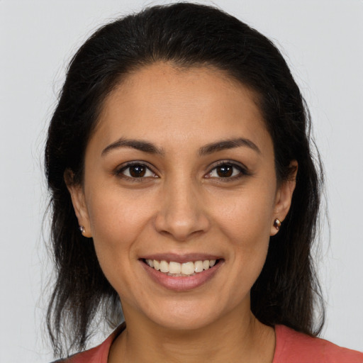 Joyful white young-adult female with long  brown hair and brown eyes