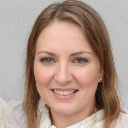 Joyful white young-adult female with medium  brown hair and blue eyes