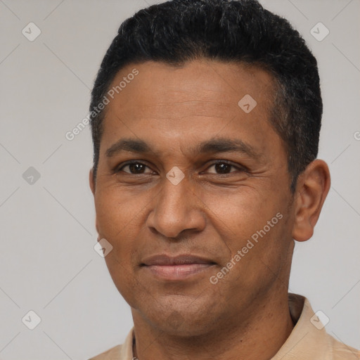 Joyful latino adult male with short  black hair and brown eyes
