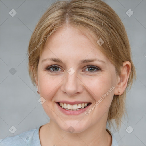 Joyful white young-adult female with medium  brown hair and blue eyes