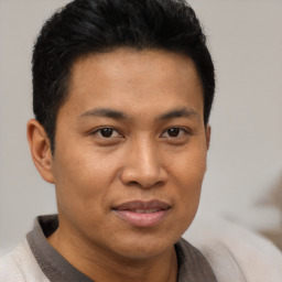 Joyful asian young-adult male with short  brown hair and brown eyes