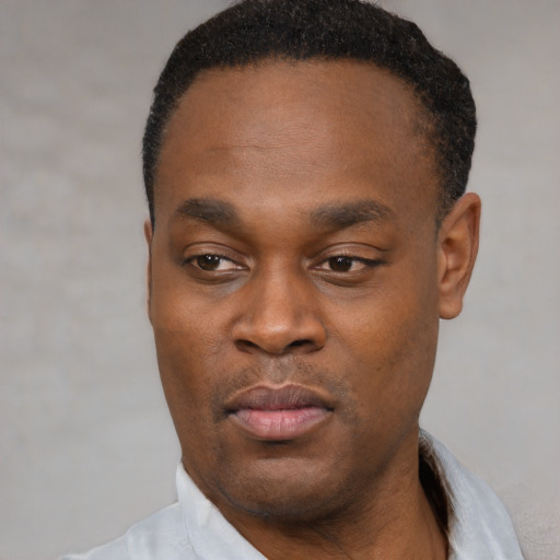 Neutral black young-adult male with short  black hair and brown eyes