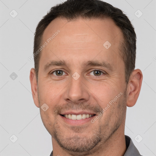 Joyful white adult male with short  brown hair and brown eyes