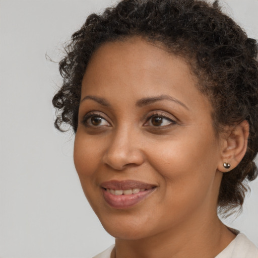 Joyful black young-adult female with medium  brown hair and brown eyes
