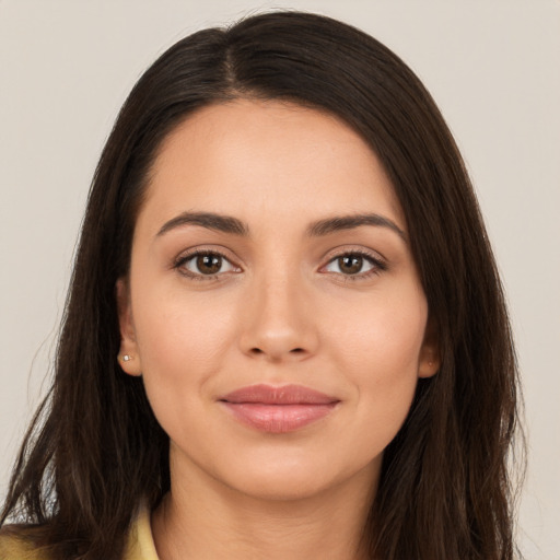 Joyful white young-adult female with long  brown hair and brown eyes