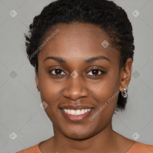 Joyful black young-adult female with short  brown hair and brown eyes