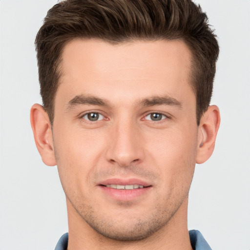 Joyful white young-adult male with short  brown hair and brown eyes