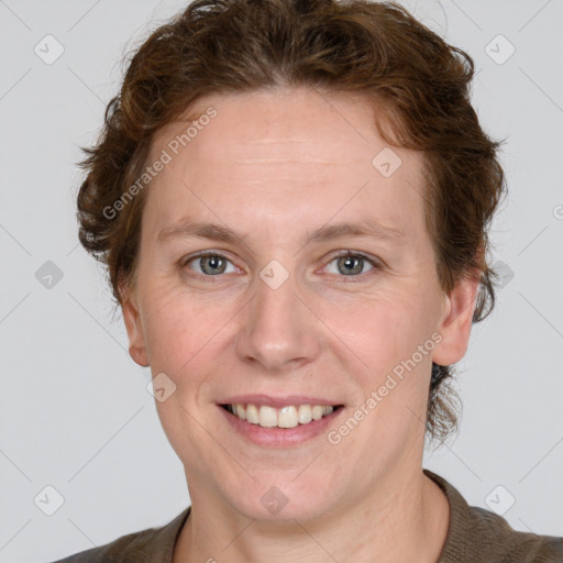 Joyful white adult female with medium  brown hair and blue eyes