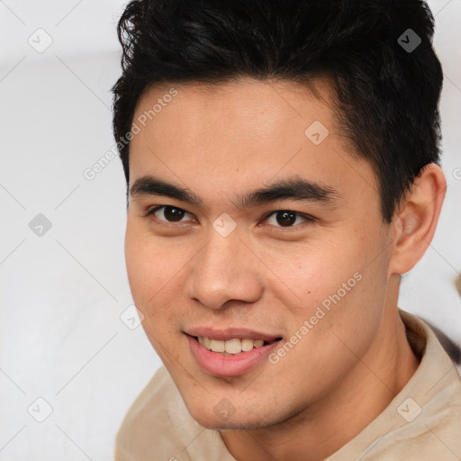 Joyful latino young-adult male with short  brown hair and brown eyes