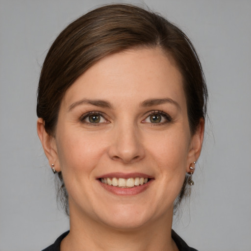 Joyful white young-adult female with medium  brown hair and grey eyes