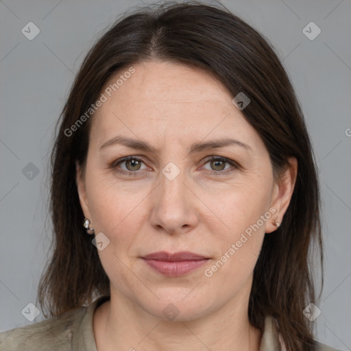 Joyful white adult female with medium  brown hair and grey eyes