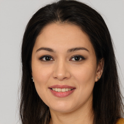Joyful latino young-adult female with long  brown hair and brown eyes