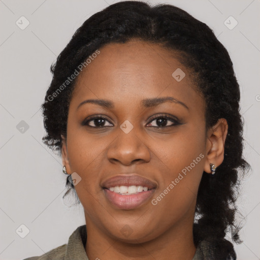 Joyful black young-adult female with long  black hair and brown eyes