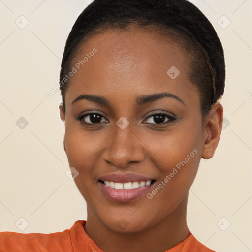 Joyful black young-adult female with short  brown hair and brown eyes