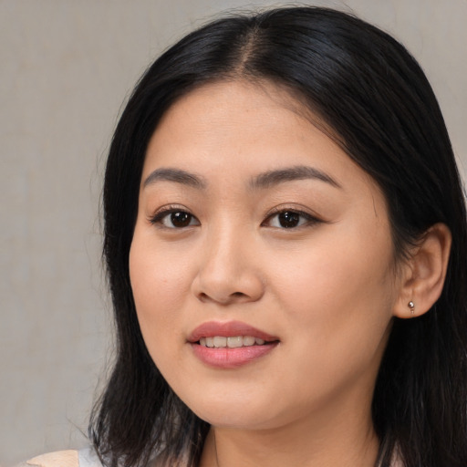 Joyful asian young-adult female with long  black hair and brown eyes