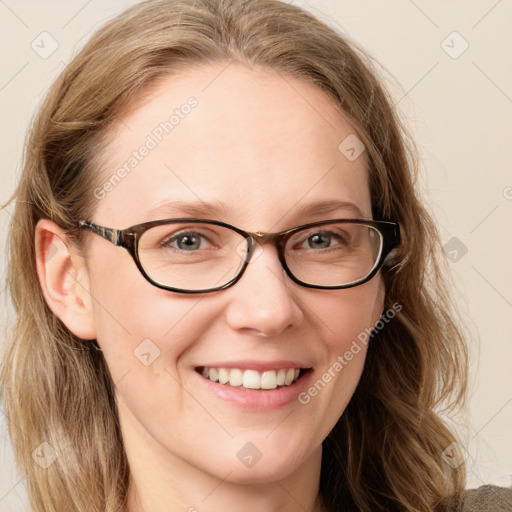 Joyful white adult female with long  brown hair and blue eyes