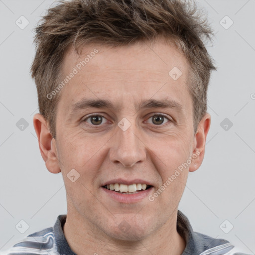 Joyful white adult male with short  brown hair and grey eyes