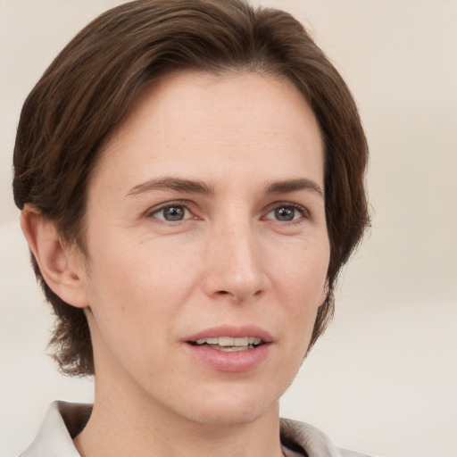 Joyful white adult female with short  brown hair and grey eyes