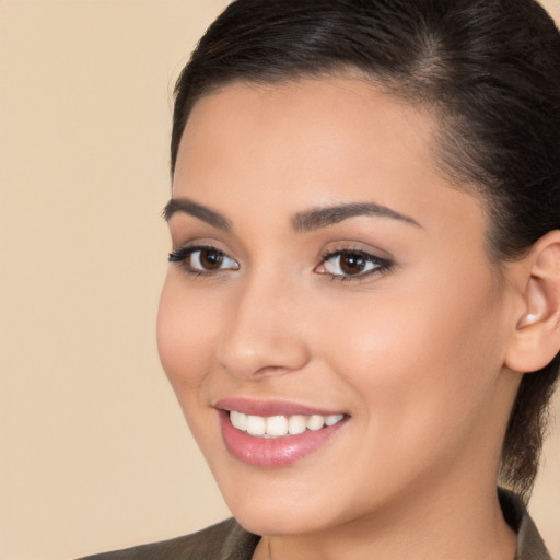 Joyful white young-adult female with long  brown hair and brown eyes