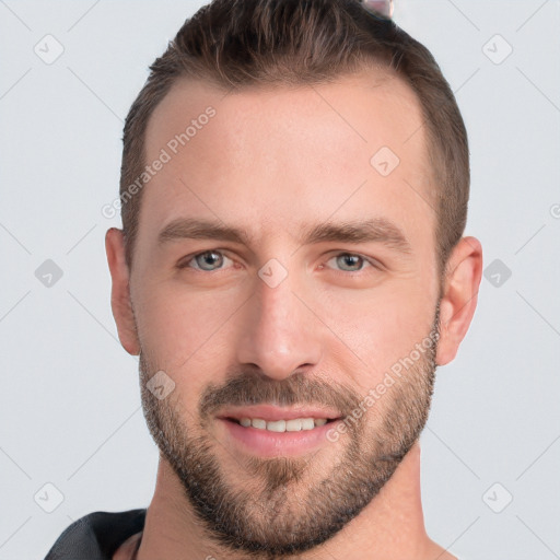 Joyful white young-adult male with short  brown hair and grey eyes