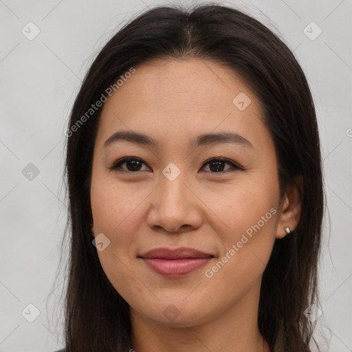 Joyful asian young-adult female with long  brown hair and brown eyes