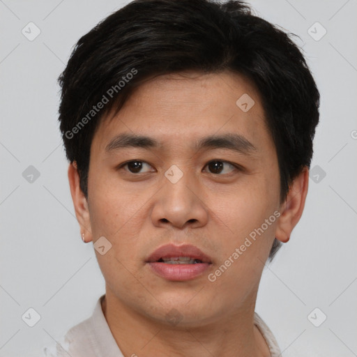 Joyful asian young-adult male with short  black hair and brown eyes
