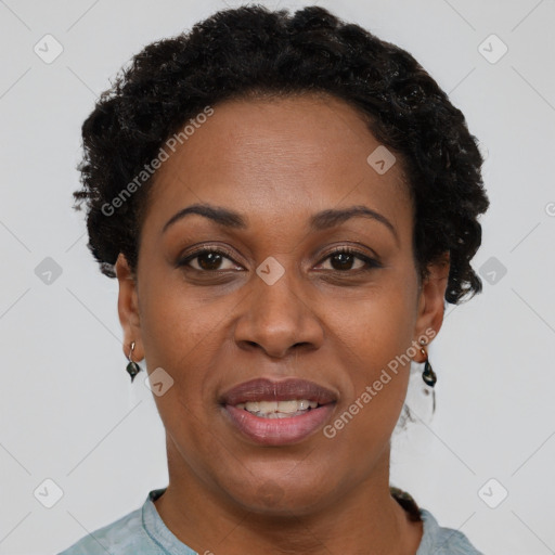 Joyful black young-adult female with short  black hair and brown eyes