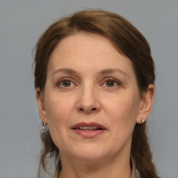 Joyful white adult female with medium  brown hair and grey eyes