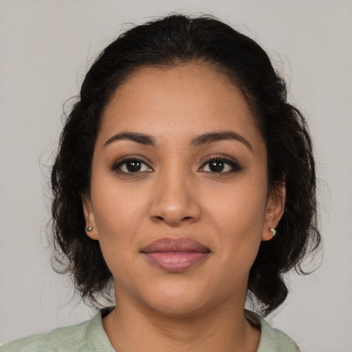 Joyful latino young-adult female with medium  brown hair and brown eyes