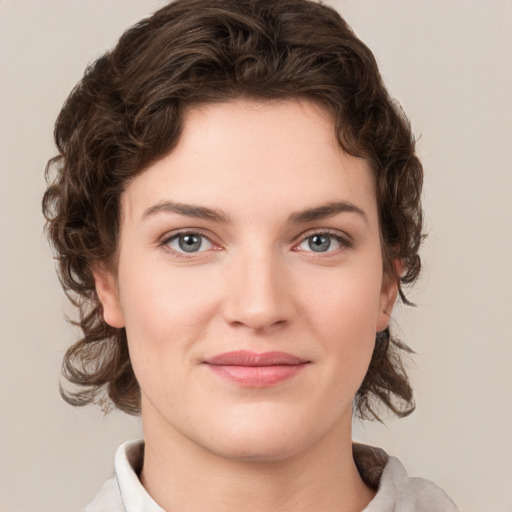 Joyful white young-adult female with medium  brown hair and green eyes