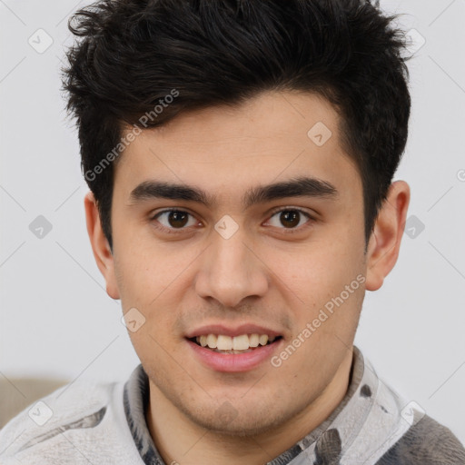 Joyful latino young-adult male with short  brown hair and brown eyes