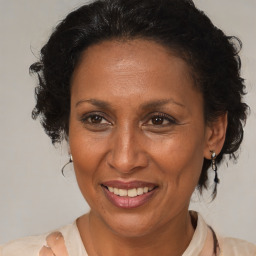 Joyful black adult female with medium  brown hair and brown eyes