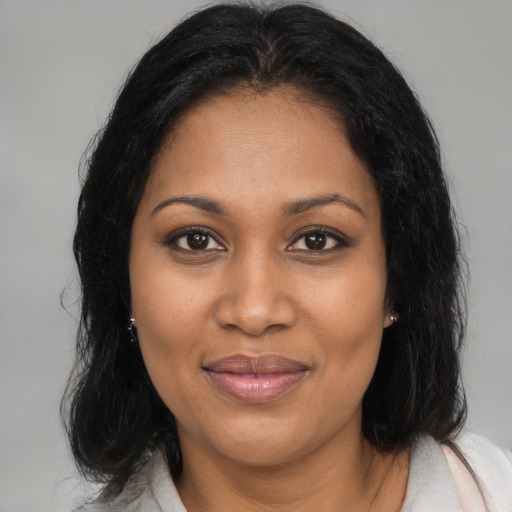 Joyful black young-adult female with medium  brown hair and brown eyes