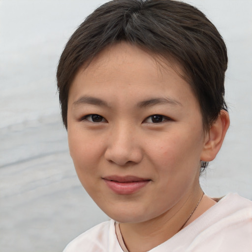 Joyful asian young-adult female with short  brown hair and brown eyes