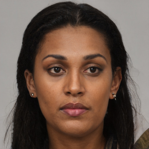 Neutral latino young-adult female with long  brown hair and brown eyes