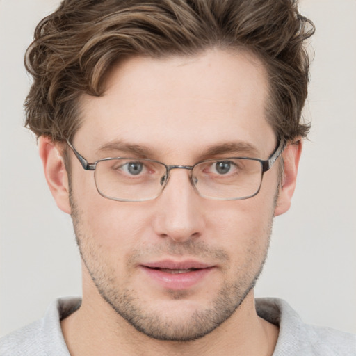 Joyful white adult male with short  brown hair and grey eyes