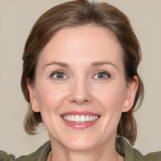 Joyful white young-adult female with medium  brown hair and blue eyes