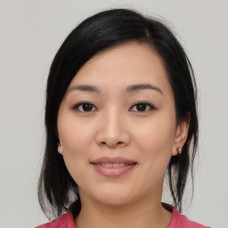 Joyful asian young-adult female with medium  black hair and brown eyes