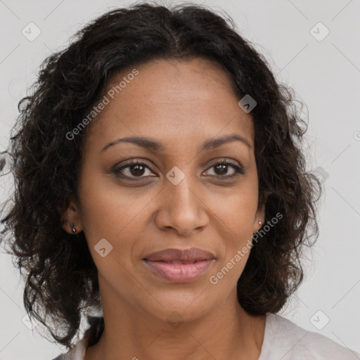 Joyful black adult female with medium  brown hair and brown eyes