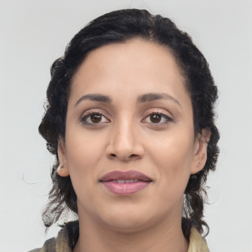 Joyful latino young-adult female with medium  brown hair and brown eyes