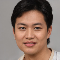 Joyful asian young-adult male with short  brown hair and brown eyes