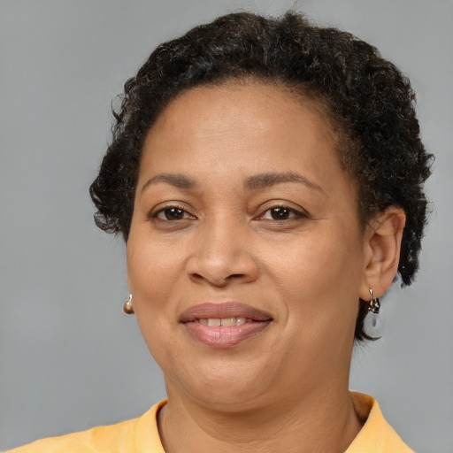 Joyful black adult female with short  brown hair and brown eyes