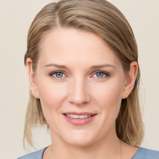 Joyful white young-adult female with medium  brown hair and blue eyes