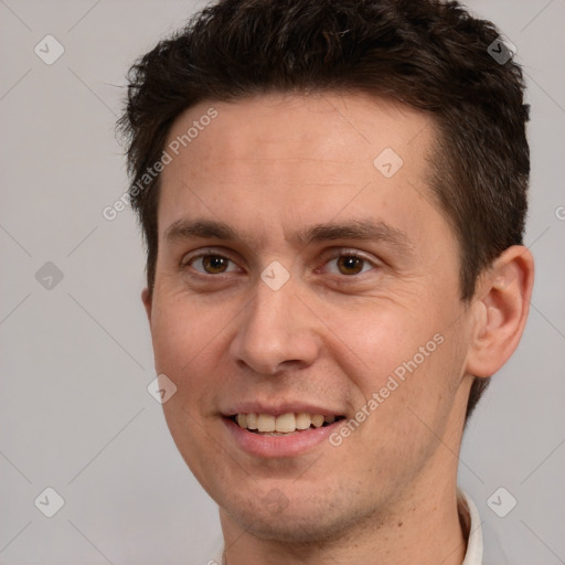 Joyful white adult male with short  brown hair and brown eyes