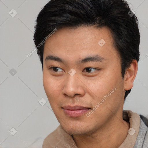 Joyful asian young-adult male with short  brown hair and brown eyes