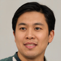 Joyful asian young-adult male with short  brown hair and brown eyes