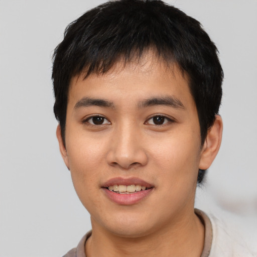 Joyful asian young-adult male with short  brown hair and brown eyes