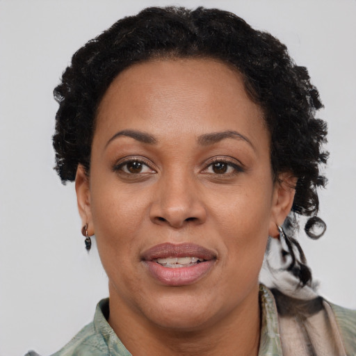 Joyful black adult female with short  brown hair and brown eyes