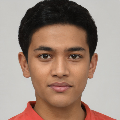 Joyful latino young-adult male with short  black hair and brown eyes