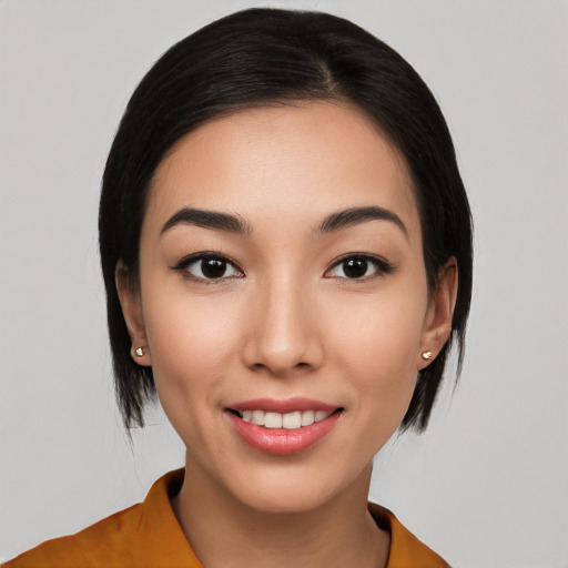 Joyful white young-adult female with medium  black hair and brown eyes